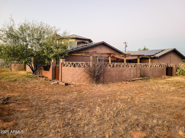 view of property exterior featuring solar panels