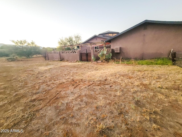 view of yard featuring a wall mounted air conditioner