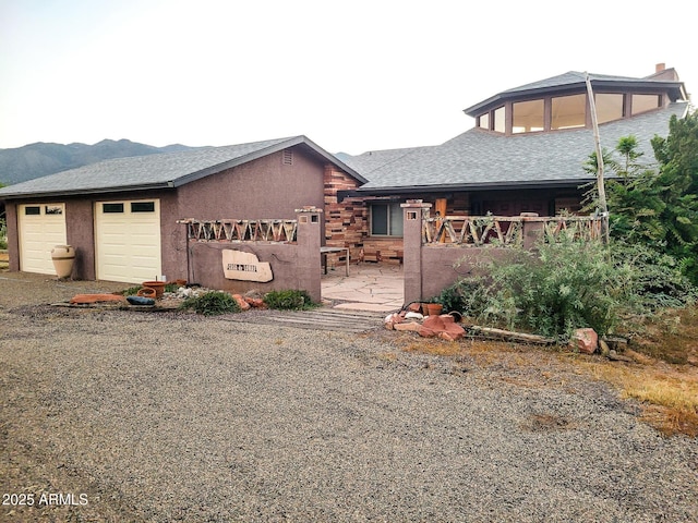 view of front of property with a garage and a mountain view