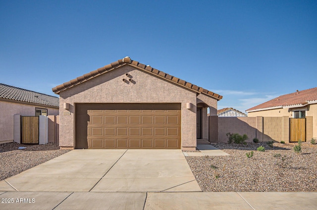 12086 E Sunflower Ln, Florence, AZ 85132 - mediterranean / spanish house with concrete driveway, stucco siding, fence, and an attached garage