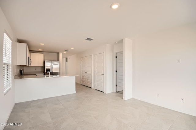 12086 E Sunflower Ln, Florence, AZ 85132 - kitchen featuring recessed lighting, stainless steel appliances, a sink, visible vents, and a peninsula
