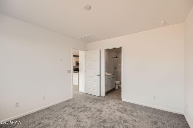 12086 E Sunflower Ln, Florence, AZ 85132 - unfurnished bedroom with carpet flooring, connected bathroom, and baseboards