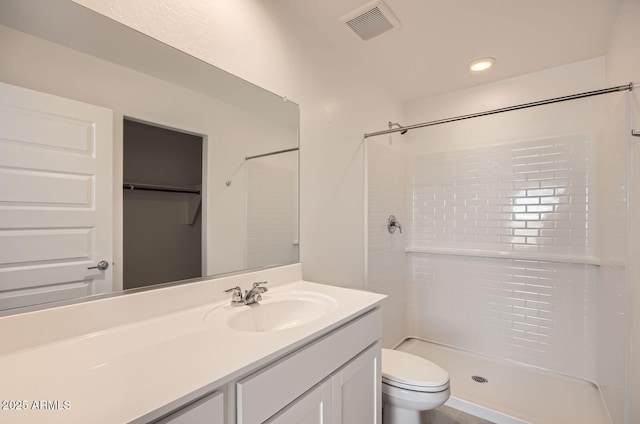 12086 E Sunflower Ln, Florence, AZ 85132 - bathroom featuring toilet, vanity, walk in shower, and visible vents