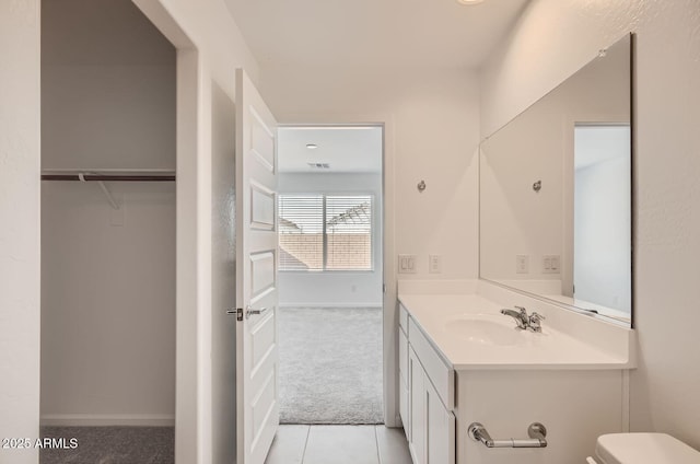12086 E Sunflower Ln, Florence, AZ 85132 - bathroom with visible vents, toilet, tile patterned floors, vanity, and a walk in closet