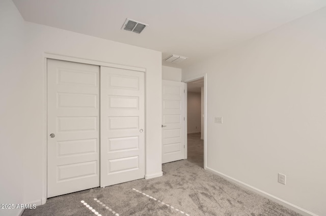 12086 E Sunflower Ln, Florence, AZ 85132 - unfurnished bedroom featuring a closet, carpet flooring, visible vents, and baseboards