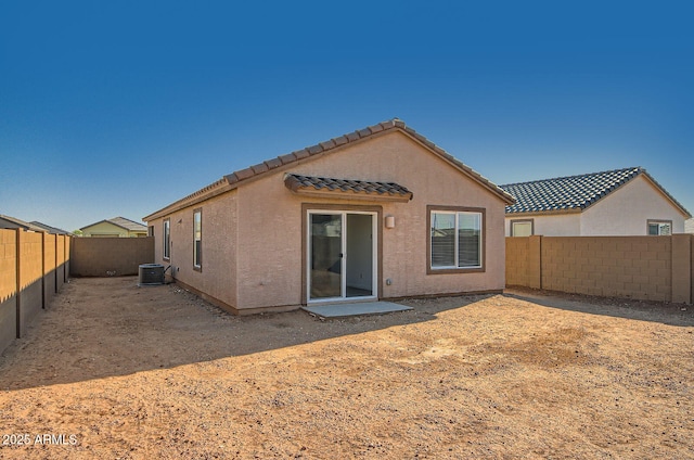 12086 E Sunflower Ln, Florence, AZ 85132 - back of house featuring a fenced backyard, a tile roof, cooling unit, and stucco siding