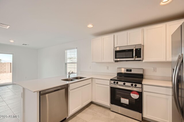12086 E Sunflower Ln, Florence, AZ 85132 - kitchen featuring visible vents, a peninsula, appliances with stainless steel finishes, white cabinetry, and a sink