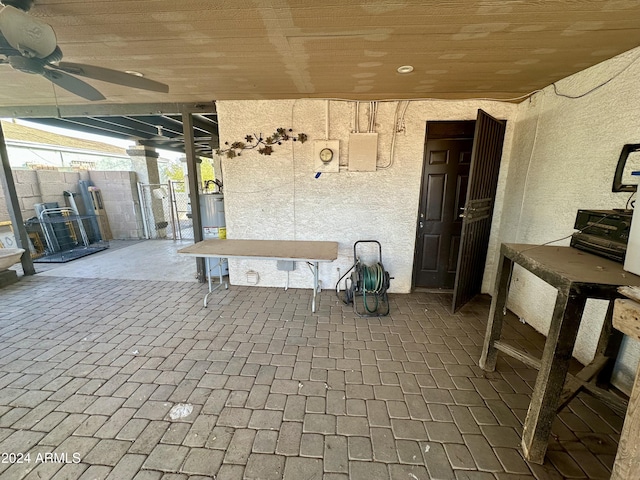 view of patio / terrace featuring ceiling fan and water heater