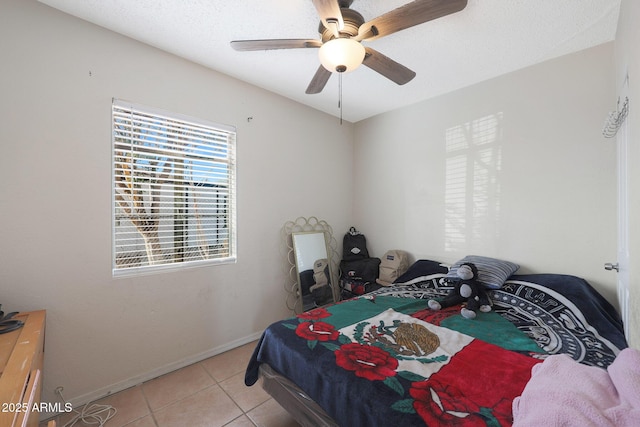 tiled bedroom featuring ceiling fan