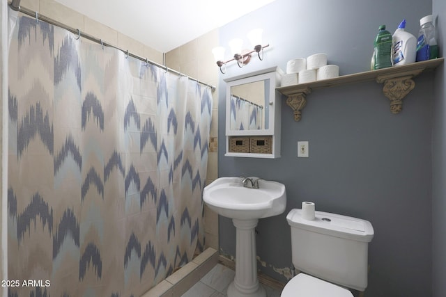 bathroom with tile patterned floors, curtained shower, and toilet