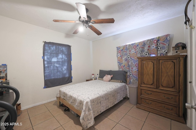 tiled bedroom featuring ceiling fan and a textured ceiling