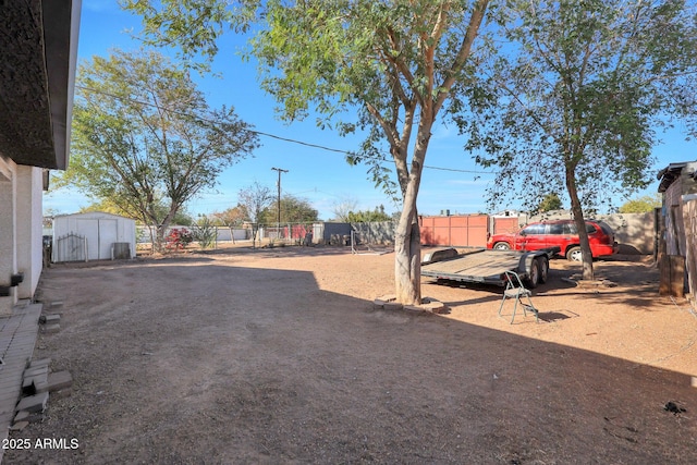 view of yard featuring a storage unit