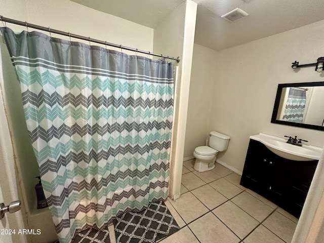 bathroom with tile patterned floors, vanity, and toilet