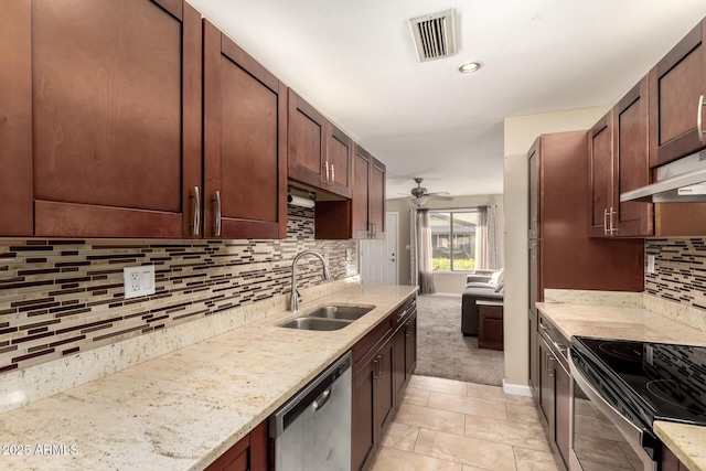 kitchen featuring sink, stainless steel appliances, light stone counters, light tile patterned flooring, and ceiling fan