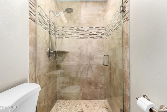 bathroom with toilet and an enclosed shower