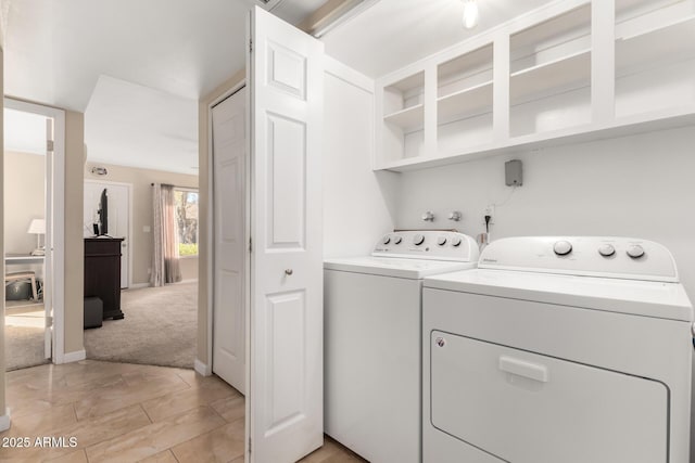 laundry room featuring independent washer and dryer and light colored carpet