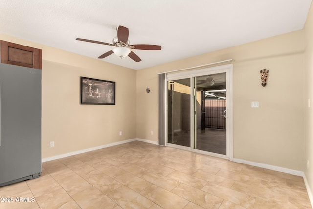 empty room featuring ceiling fan and light tile patterned floors