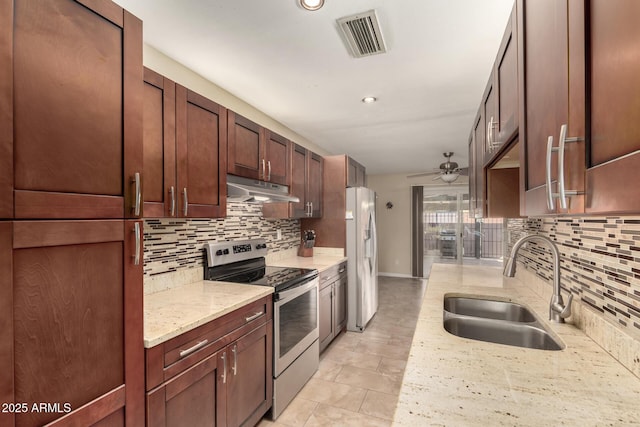 kitchen with sink, electric stove, refrigerator with ice dispenser, and light stone countertops