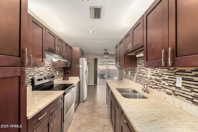 kitchen with light stone counters, tasteful backsplash, electric range, fridge, and sink