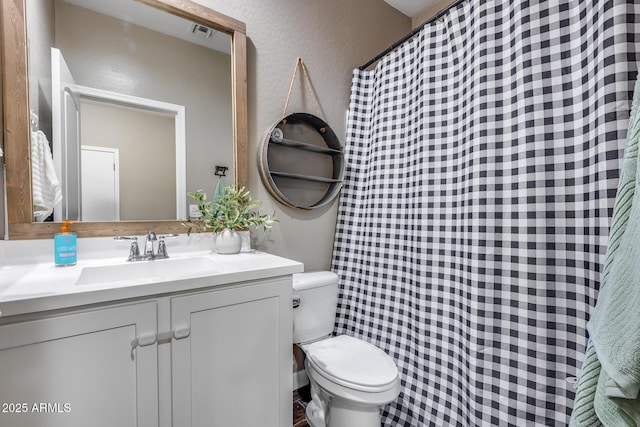 13657 W Paso Trl, Peoria, AZ 85383 - bathroom with a textured wall, toilet, vanity, and a shower with shower curtain