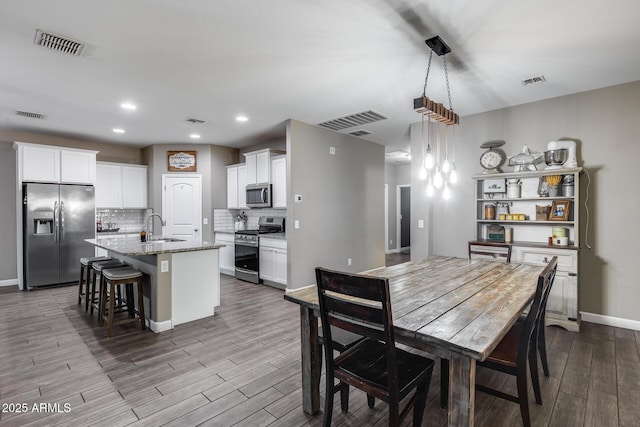 13657 W Paso Trl, Peoria, AZ 85383 - dining space featuring dark wood finished floors, baseboards, and recessed lighting