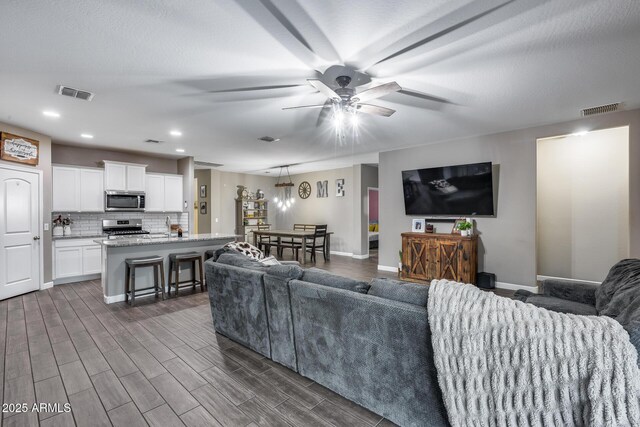 13657 W Paso Trl, Peoria, AZ 85383 - living area with a ceiling fan, recessed lighting, baseboards, and dark wood-style flooring