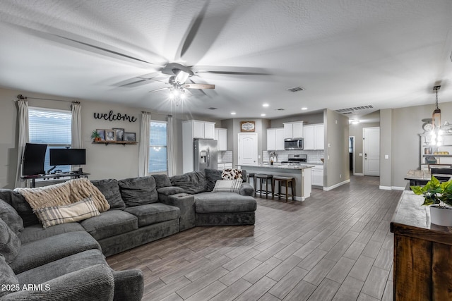 13657 W Paso Trl, Peoria, AZ 85383 - living area featuring a ceiling fan, wood finished floors, baseboards, and recessed lighting