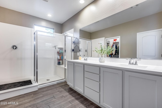 13657 W Paso Trl, Peoria, AZ 85383 - full bathroom with a stall shower, wood finished floors, double vanity, and recessed lighting
