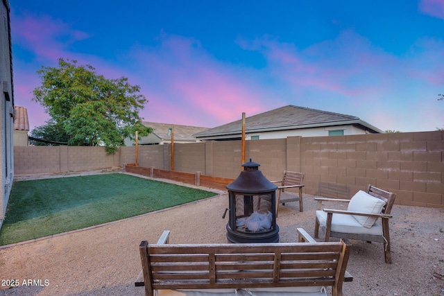 13657 W Paso Trl, Peoria, AZ 85383 - patio terrace at dusk featuring an outdoor fire pit and a fenced backyard