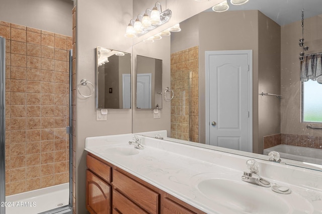 bathroom featuring shower with separate bathtub and vanity