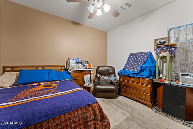 bedroom featuring ceiling fan, vaulted ceiling, and carpet