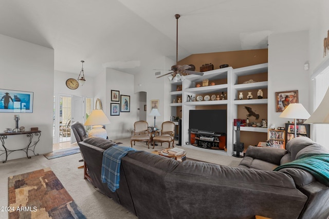 carpeted living room featuring ceiling fan, high vaulted ceiling, and built in shelves