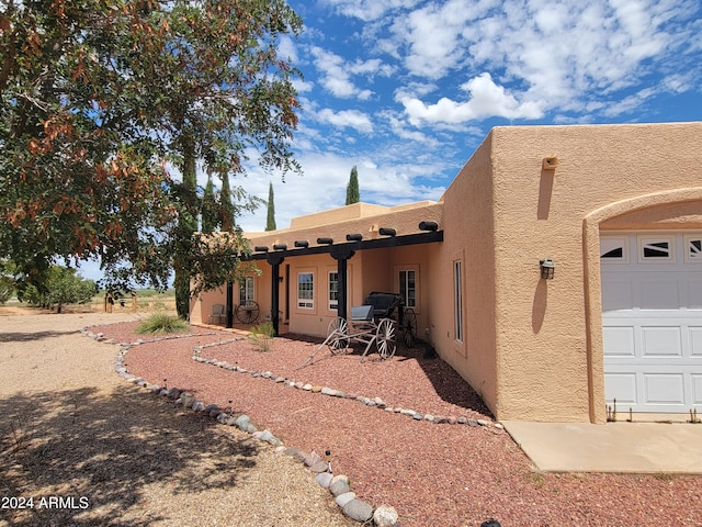 exterior space with stucco siding and a garage