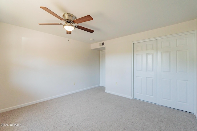 unfurnished bedroom with carpet floors, a closet, visible vents, ceiling fan, and baseboards