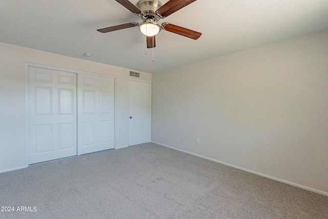 unfurnished bedroom featuring carpet floors, baseboards, visible vents, and a closet