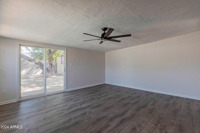 unfurnished room featuring a ceiling fan, a textured ceiling, baseboards, and dark wood-type flooring