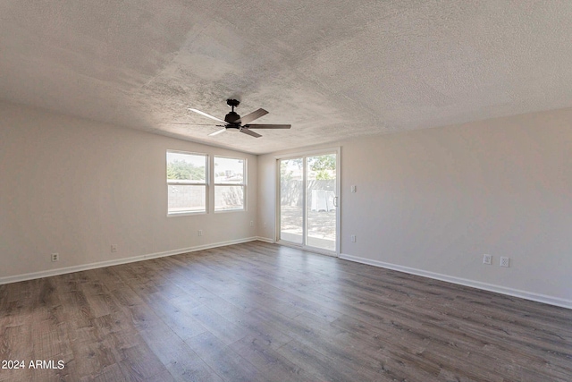 empty room with dark wood-style floors, ceiling fan, baseboards, and a textured ceiling