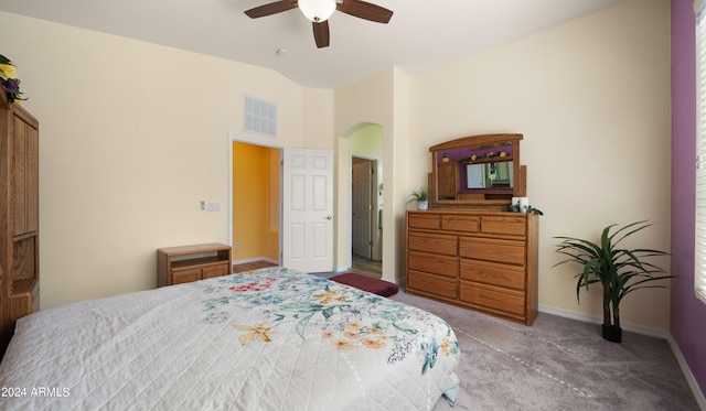 bedroom with lofted ceiling, arched walkways, a ceiling fan, visible vents, and baseboards