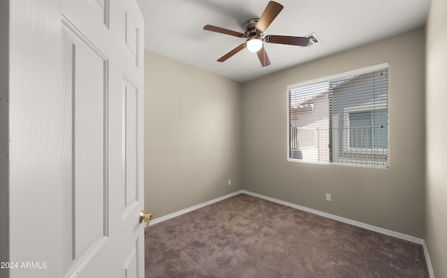 carpeted empty room featuring baseboards, visible vents, and ceiling fan