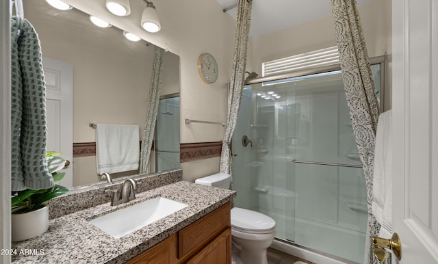 full bath featuring a shower stall, toilet, and vanity