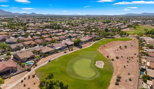 drone / aerial view with golf course view, a residential view, and a mountain view