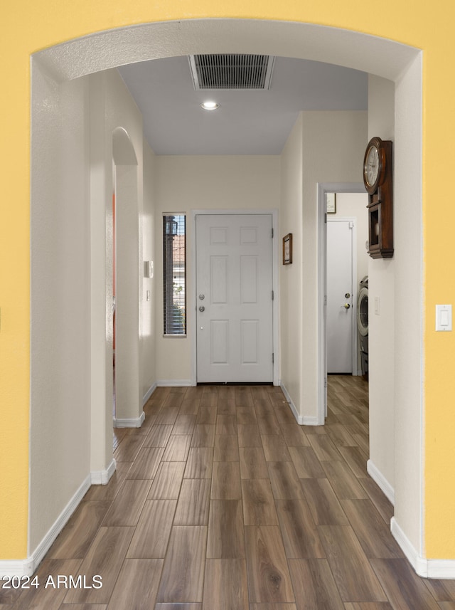 foyer featuring washer / dryer, wood finished floors, visible vents, and baseboards