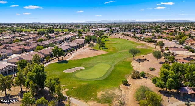 drone / aerial view with a residential view, a mountain view, and golf course view