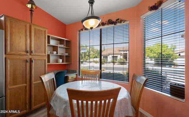 dining space featuring lofted ceiling