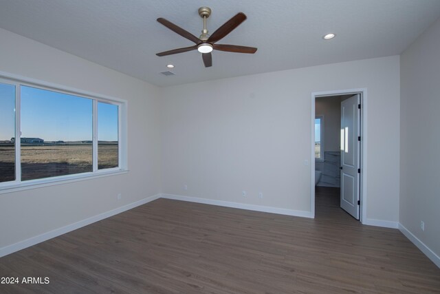 unfurnished room featuring ceiling fan and dark hardwood / wood-style flooring