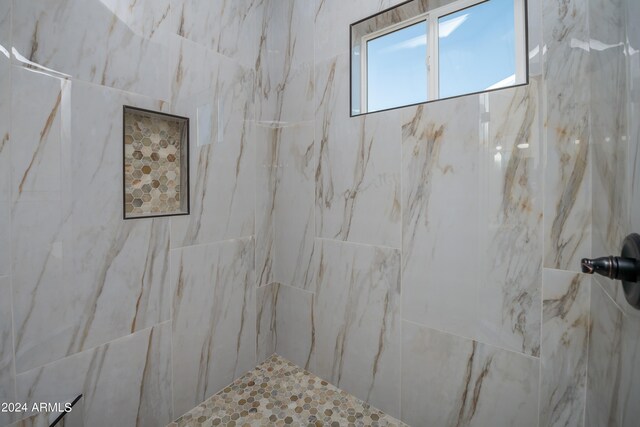 bathroom with tiled shower