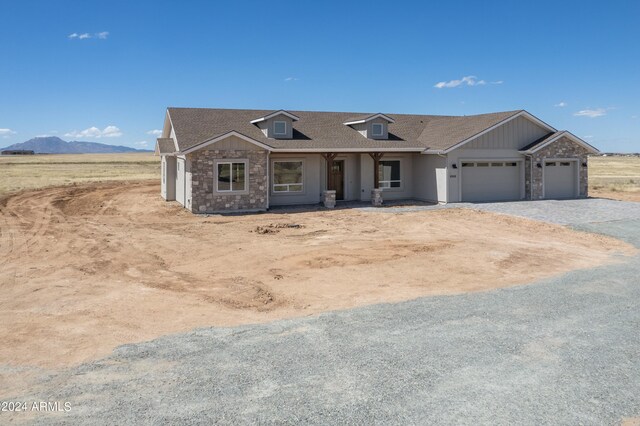 view of front of house featuring a garage and a mountain view