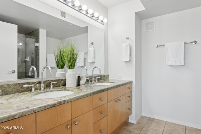 4808 N 24th St Unit 1228, Phoenix, AZ 85016 - bathroom featuring double vanity, tile patterned flooring, and a shower with shower door