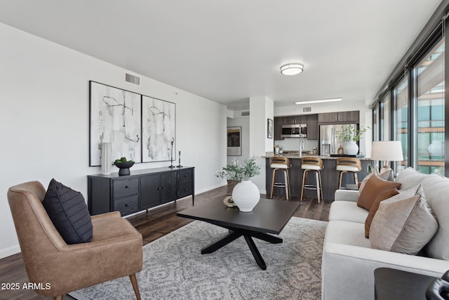 4808 N 24th St Unit 1228, Phoenix, AZ 85016 - living room featuring dark wood finished floors and baseboards