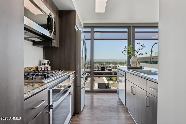 4808 N 24th St Unit 1228, Phoenix, AZ 85016 - kitchen featuring stainless steel appliances, dark wood-type flooring, healthy amount of natural light, and light countertops
